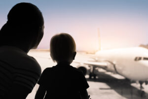 Family at airport preparing for international move from Japan to Brazil